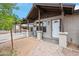 Close-up of a single-story home's entryway, with a covered carport, desert landscaping, and a cozy seating area at 2217 N 51St Ln, Phoenix, AZ 85035