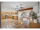 Open concept kitchen featuring wood cabinetry, tile floors, stainless steel appliances, and an adjacent dining area at 2217 N 51St Ln, Phoenix, AZ 85035
