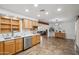 Bright kitchen view showcasing light wood cabinets, stainless steel appliances, and open view to living room at 2217 N 51St Ln, Phoenix, AZ 85035