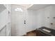 Bright laundry room with white door, shelving, and a modern washer at 2217 N 51St Ln, Phoenix, AZ 85035