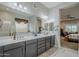 Bathroom featuring double vanity, large mirror and views to the bedroom at 2525 W Balao Dr, Phoenix, AZ 85085