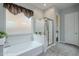 Relaxing bathroom features a soaking tub, separate shower, and frosted window at 2525 W Balao Dr, Phoenix, AZ 85085