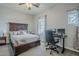 Cozy bedroom featuring a dark wood bed, a study desk, and window at 2525 W Balao Dr, Phoenix, AZ 85085