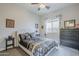 Comfortable bedroom with a decorative bed frame, dresser, and a window for natural light at 2525 W Balao Dr, Phoenix, AZ 85085