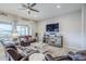 Cozy living room with tile floors, neutral paint, and a media console with a large screen TV at 2525 W Balao Dr, Phoenix, AZ 85085