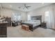 Spacious main bedroom featuring a large bed, ceiling fan, and sitting area at 2525 W Balao Dr, Phoenix, AZ 85085