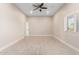 Spacious bedroom with neutral walls, wood-look tile, and a bright window view at 25450 W Pueblo Ave, Buckeye, AZ 85326
