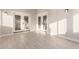 Sunlit bonus room features white tile flooring and sliding glass doors at 25450 W Pueblo Ave, Buckeye, AZ 85326