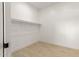 Empty closet with a single shelf and wood-style floors at 25450 W Pueblo Ave, Buckeye, AZ 85326