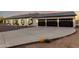 Modern home boasting a three-car garage and a well-lit driveway at dusk at 25450 W Pueblo Ave, Buckeye, AZ 85326
