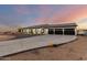 Beautiful single-story home with a long driveway, a three-car garage, and a well-manicured yard, providing both style and convenience at 25450 W Pueblo Ave, Buckeye, AZ 85326