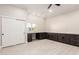 Versatile flex room with a built-in desk, storage cabinets, and a ceiling fan at 25450 W Pueblo Ave, Buckeye, AZ 85326