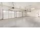 Spacious three car garage featuring a durable epoxy flooring and white doors at 25450 W Pueblo Ave, Buckeye, AZ 85326
