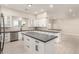 Kitchen featuring white cabinetry, stainless appliances, gray countertop, and large island at 25450 W Pueblo Ave, Buckeye, AZ 85326