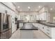 Bright kitchen features white cabinetry, stainless steel appliances, and a large island at 25450 W Pueblo Ave, Buckeye, AZ 85326