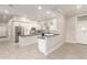 Bright kitchen with white cabinets, island, stainless appliances, and gray countertops at 25450 W Pueblo Ave, Buckeye, AZ 85326