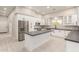 Modern kitchen with white cabinets, stainless appliances, and dark countertops at 25450 W Pueblo Ave, Buckeye, AZ 85326