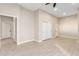 Inviting living room with light tile flooring, a closet, neutral walls, and natural light, providing comfort and style at 25450 W Pueblo Ave, Buckeye, AZ 85326