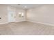 Spacious living room with light tile flooring, a white front door, neutral walls, and a window for ample natural light at 25450 W Pueblo Ave, Buckeye, AZ 85326