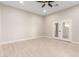 Bright and airy room with neutral walls, tiled floors, and a ceiling fan at 25450 W Pueblo Ave, Buckeye, AZ 85326