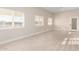Bright living room with tile floors, recessed lighting, and large windows offering outdoor views at 25450 W Pueblo Ave, Buckeye, AZ 85326