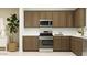 Modern kitchen with stainless steel appliances and ample cabinet space at 2944 N 98Th Ln, Phoenix, AZ 85037