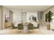 Bright living area with dining space, neutral tones and contemporary lighting at 2944 N 98Th Ln, Phoenix, AZ 85037