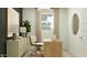 Bright home office with a modern desk, comfortable chair, and natural lighting at 2944 N 98Th Ln, Phoenix, AZ 85037