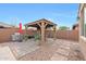 Beautiful backyard patio features a gazebo, brick pavers, BBQ, and ample space for outdoor entertainment at 3359 E Penedes Dr, Gilbert, AZ 85298