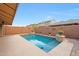 Backyard features a refreshing pool with rock decor set within an attractive block wall at 3359 E Penedes Dr, Gilbert, AZ 85298