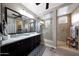 Bathroom features a double sink vanity with granite countertop and a glass-enclosed tiled shower at 3359 E Penedes Dr, Gilbert, AZ 85298