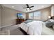 Comfortable bedroom features a dark wood dresser, a TV, and neutral-colored walls and carpet at 3359 E Penedes Dr, Gilbert, AZ 85298