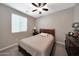 Relaxing bedroom with carpet flooring, a ceiling fan, and large window at 3359 E Penedes Dr, Gilbert, AZ 85298