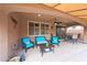 Inviting covered patio area features stylish furniture and a ceiling fan for comfortable outdoor living at 3359 E Penedes Dr, Gilbert, AZ 85298