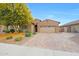 Beautiful single-story home with a well-manicured front yard and a charming brick driveway at 3359 E Penedes Dr, Gilbert, AZ 85298