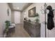 Charming entryway features a hall tree, neutral paint, wood-look tile, and views to the front door at 3359 E Penedes Dr, Gilbert, AZ 85298