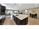 Spacious kitchen with granite island, stainless appliances, and open sight lines to the dining and living areas at 3359 E Penedes Dr, Gilbert, AZ 85298