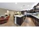 Gourmet kitchen features granite counters, stainless appliances, a large island, and dark cabinets at 3359 E Penedes Dr, Gilbert, AZ 85298