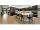 Gourmet kitchen features dark wood cabinetry, a large island, stainless appliances, and tiled backsplash at 3359 E Penedes Dr, Gilbert, AZ 85298