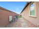 Side yard featuring gravel landscaping with pavers and a small patch of artificial turf at 3359 E Penedes Dr, Gilbert, AZ 85298