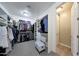 Spacious walk-in closet with ample shelving, hanging space, and a comfortable sitting area at 3359 E Penedes Dr, Gilbert, AZ 85298