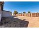 Large backyard featuring gravel cover, storage shed, mature trees, and block wall at 3422 W Poinsettia Dr, Phoenix, AZ 85029