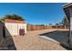 Spacious backyard with gravel cover featuring shed, block wall, and mature trees at 3422 W Poinsettia Dr, Phoenix, AZ 85029