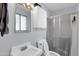 Bathroom featuring a white sink, toilet, shower, cabinet and mirror at 3422 W Poinsettia Dr, Phoenix, AZ 85029