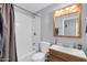 Bathroom featuring a white tub, shower, toilet, vanity, and mirror at 3422 W Poinsettia Dr, Phoenix, AZ 85029