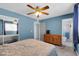 Bedroom featuring carpet flooring, dresser, closet and fan at 3422 W Poinsettia Dr, Phoenix, AZ 85029