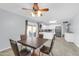 Bright dining area with a ceiling fan and view of the kitchen through sliding doors at 3422 W Poinsettia Dr, Phoenix, AZ 85029
