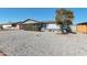 Single-story home features a low-maintenance rock yard and a mature tree full of fruit at 3422 W Poinsettia Dr, Phoenix, AZ 85029