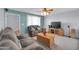 Cozy living room featuring plush sofas, neutral carpet and a wooden TV stand at 3422 W Poinsettia Dr, Phoenix, AZ 85029