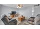 Comfortable living room with plush seating, neutral carpet and a ceiling fan at 3422 W Poinsettia Dr, Phoenix, AZ 85029